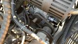 Close-up of the engine compartment of a 2024 Agt Ktt23 Stand On Skid Steer Track Loader featuring a 23HP engine with visible belts and wiring