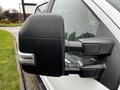 Close-up of the side mirror of a 2020 Ford F-350 SD with droplets of water on its surface