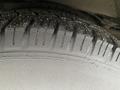 Close-up view of a tire tread on a 2017 Chevrolet Express showing deep grooves and textured surface