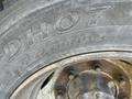 A close-up of a tire on a 2010 Freightliner MT45 Garbage Truck showing the tread pattern and tire specifications including size 2257019.5