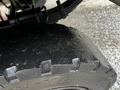 Close-up of a large rubber tire from a 2007 Tennant Sentinel showing tread patterns and visible wear on the surface