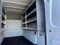 Interior view of a 2019 Ford F-350 SD cargo van featuring metal shelving on both sides with open space below for additional storage