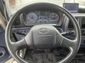 Steering wheel of a 2008 Hino Conventional Cab with various control levers and a digital display panel showing gauges and indicators