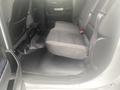 Interior view of a 2015 Chevrolet Silverado 3500HD showing the rear seat area with black fabric upholstery and floor mats