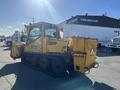 A yellow 2008 Camoplast SW 4S vehicle with a tracked chassis and a large rear-mounted bucket for snow removal