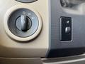 The image shows the control panel of a 2012 Ford Econoline featuring a headlight switch and additional control knobs