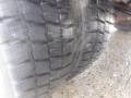 A close-up of a rugged tire tread from a 2009 Ford F-450 SD showing deep grooves and a durable rubber surface