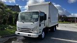 A white 2016 Isuzu NPR truck with a boxy cargo area and large front windshield