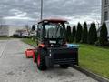 A 2018 Kubota B2650 compact tractor with a front loader attachment parked on a concrete surface