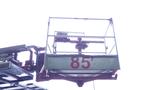 A 2010 International 4300 aerial platform with a numbered basket labeled 85 positioned for operation