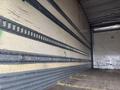 Interior view of a 2008 Hino 268 truck showing the cargo area with metal tracks on the walls for securing loads