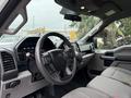 Interior view of a 2018 Ford F-150 showcasing the steering wheel dashboard and front seats with a modern layout and controls