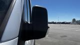 A side view mirror of a 2016 Mercedes-Benz Sprinter van