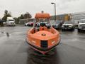 A 2008 Fassmer 20 Foot Fast Rescue boat in bright orange with a streamlined hull and a central console cockpit visible from the front