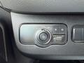 A control panel in a 2019 Mercedes-Benz Sprinter featuring various switches and a dial for headlight settings