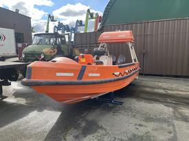 A 2007 Fassmer 20 Foot Fast Rescue Boat in bright orange with a streamlined hull and twin seating at the helm