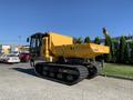 A yellow 2022 TerraMac RT7R tracked vehicle with a large dump box attached, featuring heavy-duty tracks and a cab on the left side