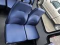 A pair of blue fabric seats from a 2017 Chevrolet Express van arranged side by side on a vehicle interior