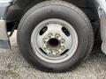 A close-up of a Michelin tire mounted on a silver wheel from a 2017 Chevrolet Express showing visible bolts and a tread pattern