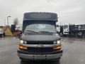 A black 2018 Chevrolet Express van with a large box-style body and a prominent Chevrolet emblem on the front grille