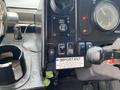 Interior dashboard of a 2005 Freightliner MT45 Chassis featuring control switches a fan and a parking brake lever