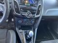 Interior view of a 2018 Ford Focus featuring a touchscreen display audio system climate controls and a manual gear shifter