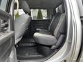 Interior view of a 2012 RAM 3500 showing the back seat area with two upright seats in gray fabric and a rubber floor mat