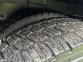 A close-up of a tire with deep tread patterns highlighting its rugged texture and wear showing on a 2007 International 4200