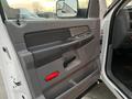 Interior door panel of a 2008 Dodge Ram 5500 featuring gray plastic with a red door handle and control buttons for windows and locks