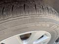 Close-up of a tire from a 2007 Toyota Camry Hybrid showing the tread patterns and a part of the silver alloy wheel