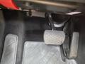 The footwell of a 2007 Mercedes-Benz E-Class featuring a clear brake pedal a rubber floor mat and an accelerator pedal