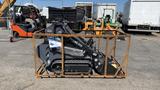 2024 Agt Ktt23 Stand On Skid Steer Track Loader 23HP in a wooden crate with tracks visible and various attachments on the side