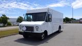 A white 2011 Ford Econoline truck with a boxy shape and closed cargo area parked on a lot