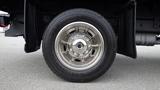 A close-up view of a chrome wheel with a Continental tire mounted on a 2008 Ford F-450 SD truck