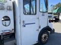 2010 Freightliner MT45 Garbage Truck with a white exterior featuring Waste Management Division signage and large front wheels