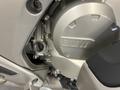 Close-up of the engine casing of a 2013 BMW K1600GTL featuring the BMW logo and a polished metallic finish