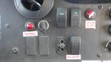 Dashboard controls of a 2011 Ford Econoline including switches for lights fans and door ajar indicator with labels for seatbelt and right door