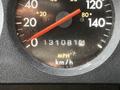 Close-up of a speedometer from a 1994 Freightliner FL80 showing the needle pointing at zero with the odometer reading 1310814 miles