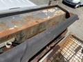 Close-up of a rusty metal surface and a black mesh cover, part of a 2010 Ford F-550 vehicle