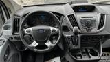 Interior view of a 2017 Ford Transit showing the steering wheel dashboard and center console with controls and display screen