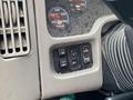 Dashboard controls of a 2018 International 26 Foot Cube featuring buttons for air conditioning panel and various gauges for oil and transmission temperatures