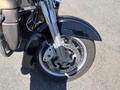 Close-up of the front wheel and fork of a 2004 Harley-Davidson Flhtcui showcasing the brake system and tire design