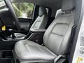 Interior view of a 2019 Chevrolet Colorado showing the driver's seat and center console with a gear shifter and storage compartment