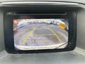 Display screen showing a rearview camera view with guidelines and a prompt to check surroundings for safety