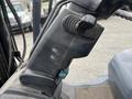 A close-up view of the control panel and steering mechanism of a 2011 Toyota Forklift showing various levers and buttons