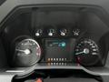 Dashboard of a 2014 Ford F-550 displaying gauges for speed fuel and engine temperature along with a trip information screen