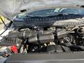 Close-up of the engine compartment of a 2019 Ford F-350 SD featuring a large black air intake and various engine components with visible wiring and a battery terminal
