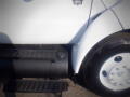 White 2007 Ford F-650 truck with a black fuel tank and step plate on the side