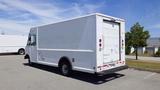 White 2011 Ford Econoline van parked with a boxy cargo area and rear roll-up door