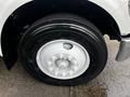 Close-up of a wheel from a 2008 Ford F-750 featuring a large black tire with a white rim and multiple bolts
